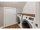 Well-organized laundry room with wood countertop and modern appliances with ample storage space at 2450 S Us 421, Zionsville, IN 46077