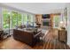 Comfortable living room with fireplace, wooden floor, and large windows at 2450 S Us 421, Zionsville, IN 46077