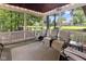 Relax on the screened-in porch overlooking the backyard with comfortable seating and serene views at 2450 S Us 421, Zionsville, IN 46077