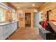 Spacious tack room with wood paneled walls, storage benches, cabinetry, and well-organized equestrian supplies at 2450 S Us 421, Zionsville, IN 46077