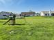 Large backyard with a play set, offering plenty of room for outdoor activities at 261 Punkin Ct, Greenfield, IN 46140
