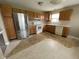Galley kitchen features wood cabinets, white appliances, and ample counter space at 261 Punkin Ct, Greenfield, IN 46140