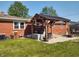 Cozy backyard with a brick house, an outdoor seating area, and a paved patio at 2630 Wedgewood Dr, Columbus, IN 47203