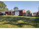Spacious backyard with a shed, featuring a garage-style door and fenced perimeter for privacy at 2630 Wedgewood Dr, Columbus, IN 47203
