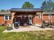 Backyard featuring a patio area with a pergola, outdoor seating, and mature trees at 2630 Wedgewood Dr, Columbus, IN 47203