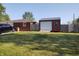 Backyard with a view of a detached garage featuring a metal roof and wooden fence at 2630 Wedgewood Dr, Columbus, IN 47203