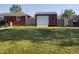 Backyard with a view of a detached garage featuring a metal roof and wooden fence at 2630 Wedgewood Dr, Columbus, IN 47203