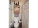Bathroom with a toilet and a cabinet with a towel rack at 2630 Wedgewood Dr, Columbus, IN 47203