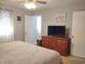 Bright bedroom with bed, dresser with TV, closet and light-filled ambiance at 2630 Wedgewood Dr, Columbus, IN 47203