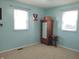 Light blue bedroom with wardrobe, stool, carpet and two windows at 2630 Wedgewood Dr, Columbus, IN 47203