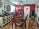 Spacious dining room with laminate flooring, red accent wall, and dark wood table at 2630 Wedgewood Dr, Columbus, IN 47203