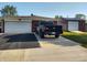 Extended driveway leading to a garage, with a truck, home and storage shed at 2630 Wedgewood Dr, Columbus, IN 47203