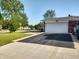 Large driveway leading to a two car garage on this brick home in a treed neighborhood at 2630 Wedgewood Dr, Columbus, IN 47203