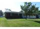 Single story brick home with a white picket fence and lush green lawn at 2630 Wedgewood Dr, Columbus, IN 47203
