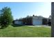 Brick home with an attached garage surrounded by a green lawn at 2630 Wedgewood Dr, Columbus, IN 47203
