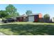 Charming single-story home with a detached garage, well-maintained lawn and mature trees at 2630 Wedgewood Dr, Columbus, IN 47203