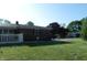 Charming single-story brick home with a well-manicured lawn, picket fence, and mature tree at 2630 Wedgewood Dr, Columbus, IN 47203