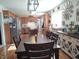 Bright kitchen features wood cabinets, stainless steel appliances, and long dark wood dining table at 2630 Wedgewood Dr, Columbus, IN 47203