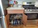 Featuring a stainless steel oven range and organized storage with rollout pan organizers at 2630 Wedgewood Dr, Columbus, IN 47203