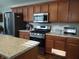 Bright kitchen featuring stainless steel appliances, a granite countertop island, and wooden cabinets at 2630 Wedgewood Dr, Columbus, IN 47203