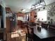 Open kitchen layout with stainless steel appliances, an island, a dining table, and laminate flooring at 2630 Wedgewood Dr, Columbus, IN 47203