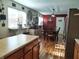 Kitchen and dining room with laminate flooring, stainless steel appliances, and dining table at 2630 Wedgewood Dr, Columbus, IN 47203