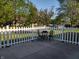 Inviting outdoor patio area with white picket fence, table and chairs at 2630 Wedgewood Dr, Columbus, IN 47203