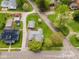 An aerial view of the home showcases its lot, garage, and neighboring houses in the quiet neighborhood at 300 E 2Nd St, Sheridan, IN 46069