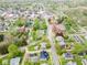 An aerial view of a home in a residential area with mature trees and a detached garage and yellow property lines at 300 E 2Nd St, Sheridan, IN 46069