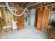 Unfinished basement with exposed pipes and ductwork at 300 E 2Nd St, Sheridan, IN 46069