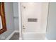 Bathroom features white tiled shower/tub with modern fixtures and a tiled inset at 300 E 2Nd St, Sheridan, IN 46069