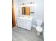 Updated bathroom features double vanity, new lighting fixtures, and modern toilet at 300 E 2Nd St, Sheridan, IN 46069