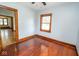 This bedroom features hardwood floors, natural light, and a fresh color palette at 300 E 2Nd St, Sheridan, IN 46069
