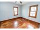 Empty bedroom featuring worn hardwood floors, neutral walls, and natural light at 300 E 2Nd St, Sheridan, IN 46069