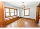 The dining room shows built-in seating with hardwood floors, a light fixture and natural light at 300 E 2Nd St, Sheridan, IN 46069