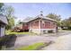 Rear exterior view of a home featuring a deck, mature trees and well-manicured lawn at 300 E 2Nd St, Sheridan, IN 46069