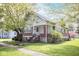 Charming craftsman-style home features red brick accents, a cozy front porch, and a well-manicured lawn with mature trees at 300 E 2Nd St, Sheridan, IN 46069