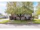 Traditional home with a large tree in the front yard with steps leading to a porch on either side of the home at 300 E 2Nd St, Sheridan, IN 46069