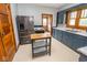 Spacious kitchen featuring stainless steel appliances, movable center island, and custom cabinets at 300 E 2Nd St, Sheridan, IN 46069