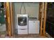 Convenient laundry area with a modern front-load washer and dryer in the unfinished basement at 300 E 2Nd St, Sheridan, IN 46069