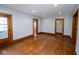The living room shows original wood floors and trim with neutral paint and natural light at 300 E 2Nd St, Sheridan, IN 46069