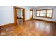An open living room features a window, hardwood floors, natural lighting, and decorative wood trim at 300 E 2Nd St, Sheridan, IN 46069