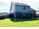 Spacious backyard with lush green grass, a fence, and mature trees at 3085 Oakmont Dr, Lapel, IN 46051