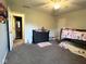 Comfortable bedroom with a dresser, bunk bed, and a view into the attached bathroom at 3085 Oakmont Dr, Lapel, IN 46051