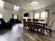 Light-filled dining area with a wooden table, stylish chairs, and modern lighting fixture at 3085 Oakmont Dr, Lapel, IN 46051