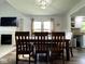 Dining room with wood table, chairs, fireplace, and kitchen access, perfect for entertaining at 3085 Oakmont Dr, Lapel, IN 46051