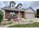 Charming brick home with curb appeal, featuring a two-car garage, dormer windows and covered front porch at 3085 Oakmont Dr, Lapel, IN 46051