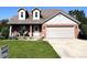 Charming brick home with a two-car garage and well-manicured lawn at 3085 Oakmont Dr, Lapel, IN 46051