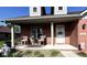 Charming brick home features a cozy front porch with seating and manicured landscaping at 3085 Oakmont Dr, Lapel, IN 46051
