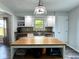 Bright kitchen offers a center island, stainless steel sink and a mosaic backsplash at 3085 Oakmont Dr, Lapel, IN 46051